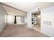 Spacious living room with plush carpet, a sliding glass door to balcony, and adjacent, bright kitchen at 3748 Idlebrook Cir # 202, Casselberry, FL 32707