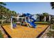 A colorful playground with swings, slides and climbing structures, all surrounded by lush landscaping at 3748 Idlebrook Cir # 202, Casselberry, FL 32707