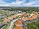 Panoramic aerial view of a community with red tile roofs and pools, surrounded by green spaces and serene lakes at 391 Cabello Dr, Davenport, FL 33837