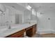 Bathroom featuring double sinks, a large mirror, and a glass-enclosed walk-in shower at 391 Cabello Dr, Davenport, FL 33837