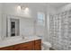 Bathroom with a vanity, neutral walls, a toilet, a large mirror, and a shower with a gray cat-themed curtain at 391 Cabello Dr, Davenport, FL 33837