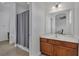 Bathroom featuring a gray shower curtain, tiled floor and vanity with a large mirror at 391 Cabello Dr, Davenport, FL 33837