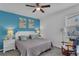 Charming bedroom with a queen bed, stylish blue accent wall, and comfortable furnishings at 391 Cabello Dr, Davenport, FL 33837