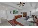 Bedroom with a dark wood sleigh bed, mounted TV, and an adjacent ensuite bathroom at 391 Cabello Dr, Davenport, FL 33837