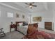 Bedroom with a dark wood sleigh bed, ceiling fan, and a vibrant, patterned rug at 391 Cabello Dr, Davenport, FL 33837