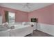 Pink bedroom featuring a ceiling fan and white furnishings, providing a peaceful retreat at 391 Cabello Dr, Davenport, FL 33837