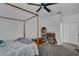 Bedroom featuring a wooden four-poster bed, gray carpet, and built-in shelving for ample storage at 391 Cabello Dr, Davenport, FL 33837