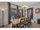 Dining room featuring a wooden table with seating for eight, a chandelier, and access to the lanai at 391 Cabello Dr, Davenport, FL 33837