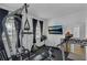 A home exercise room with a variety of equipment and natural light at 391 Cabello Dr, Davenport, FL 33837