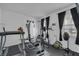 Home exercise room featuring a treadmill, weightlifting equipment, and a window for natural light at 391 Cabello Dr, Davenport, FL 33837