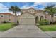Charming two-story home with a two car garage, manicured lawn, and beautiful flowering bushes at 391 Cabello Dr, Davenport, FL 33837