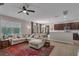 Open-concept living room with tile floors, a ceiling fan, and a comfortable sectional sofa at 391 Cabello Dr, Davenport, FL 33837