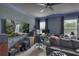 Living room with a large television, gray sofa, and windows with natural light at 391 Cabello Dr, Davenport, FL 33837