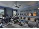 Comfortable living room with gray sofa, guitars on the wall, ceiling fan, and blue LED accent lighting at 391 Cabello Dr, Davenport, FL 33837