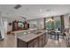 Open-concept living space with modern kitchen, dining area, and cozy living room at 391 Cabello Dr, Davenport, FL 33837
