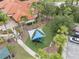 Aerial view of the community playground with play equipment, benches, shade, and landscaping at 391 Cabello Dr, Davenport, FL 33837