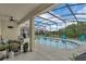 Inviting pool area with a screened enclosure, featuring comfortable seating and tropical views at 391 Cabello Dr, Davenport, FL 33837