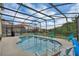 Spacious screened pool with lounge chairs and views of the surrounding trees in the backyard at 391 Cabello Dr, Davenport, FL 33837