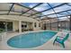 A refreshing in-ground pool is enclosed by a screened lanai with ample deck space for outdoor seating at 391 Cabello Dr, Davenport, FL 33837