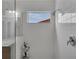 Modern tiled walk-in shower with a window and a shower caddy at 391 Cabello Dr, Davenport, FL 33837