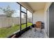 Cozy screened lanai provides a relaxing outdoor space with views of the fenced backyard at 394 Quayside Ave, Mascotte, FL 34753