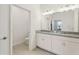 Bright bathroom with double sink vanity featuring granite countertops and modern lighting at 394 Quayside Ave, Mascotte, FL 34753