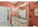 Charming bathroom features granite countertop, white cabinets, dual sinks, and large mirror at 394 Quayside Ave, Mascotte, FL 34753