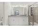 Bright bathroom featuring double vanity with granite countertop and glass-enclosed shower at 394 Quayside Ave, Mascotte, FL 34753