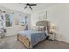 Cozy bedroom with queen-sized bed, ceiling fan, and two windows providing natural light at 394 Quayside Ave, Mascotte, FL 34753