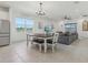 Dining room with large window and view open to living room featuring a stylish ceiling fan at 394 Quayside Ave, Mascotte, FL 34753