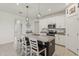 Modern kitchen featuring granite countertops and a center island with seating at 394 Quayside Ave, Mascotte, FL 34753