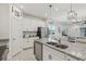 Bright kitchen featuring stainless steel appliances and a granite-topped island at 394 Quayside Ave, Mascotte, FL 34753