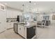 Open concept kitchen featuring a granite island and seamless flow into the living area at 394 Quayside Ave, Mascotte, FL 34753