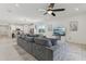 Spacious living room with comfortable seating, a large TV, and an open concept to the kitchen at 394 Quayside Ave, Mascotte, FL 34753