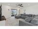 Comfortable living room with sliding glass doors leading to outdoor space and neutral patterned rug at 394 Quayside Ave, Mascotte, FL 34753