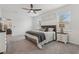 Relaxing main bedroom with neutral tones, a ceiling fan, and large windows for ample natural light at 394 Quayside Ave, Mascotte, FL 34753