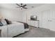 Simple main bedroom with dresser and television opposite bed at 394 Quayside Ave, Mascotte, FL 34753