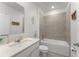 Bathroom featuring a shower-tub combo, quartz countertops, and tiled walls at 3941 Willowbrook Dr, Edgewater, FL 32141