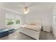 Bright bedroom boasts natural light, neutral carpet, ceiling fan, and a comfortable bed with matching nightstands at 3941 Willowbrook Dr, Edgewater, FL 32141