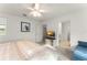 This bedroom features a ceiling fan, carpet, natural light, and TV stand with TV at 3941 Willowbrook Dr, Edgewater, FL 32141