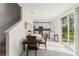 Dining area with seating for four, next to a modern kitchen featuring stainless steel appliances and subway tile backsplash at 3941 Willowbrook Dr, Edgewater, FL 32141