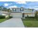 Charming two-story home featuring a two-car garage, manicured lawn, and energy-efficient solar panels at 3941 Willowbrook Dr, Edgewater, FL 32141