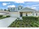 Charming two-story home with manicured front yard, covered porch, and inviting curb appeal at 3941 Willowbrook Dr, Edgewater, FL 32141