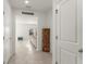 Neutral hallway showcases tiled floors and white doors, offering a glimpse into a cozy living area at 3941 Willowbrook Dr, Edgewater, FL 32141