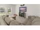Comfortable living room featuring natural light, neutral colors, large TV and sectional sofa at 3941 Willowbrook Dr, Edgewater, FL 32141
