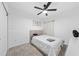 This bedroom features gray carpet, white walls, ceiling fan, and a queen bed, creating a cozy, comfortable space at 3977 Willowbrook Dr, Edgewater, FL 32141