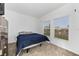 Cozy bedroom featuring plush carpet, a comfortable bed, and two windows providing natural light at 3977 Willowbrook Dr, Edgewater, FL 32141
