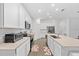 Modern kitchen with a large island, stainless steel appliances, and white cabinetry offers ample counter space at 3977 Willowbrook Dr, Edgewater, FL 32141