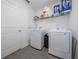 Functional laundry room equipped with modern washer and dryer, ample storage, and tiled flooring for convenience at 3977 Willowbrook Dr, Edgewater, FL 32141