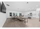 Spacious living room with comfortable seating and large windows offer a view of the kitchen and dining area at 3977 Willowbrook Dr, Edgewater, FL 32141
